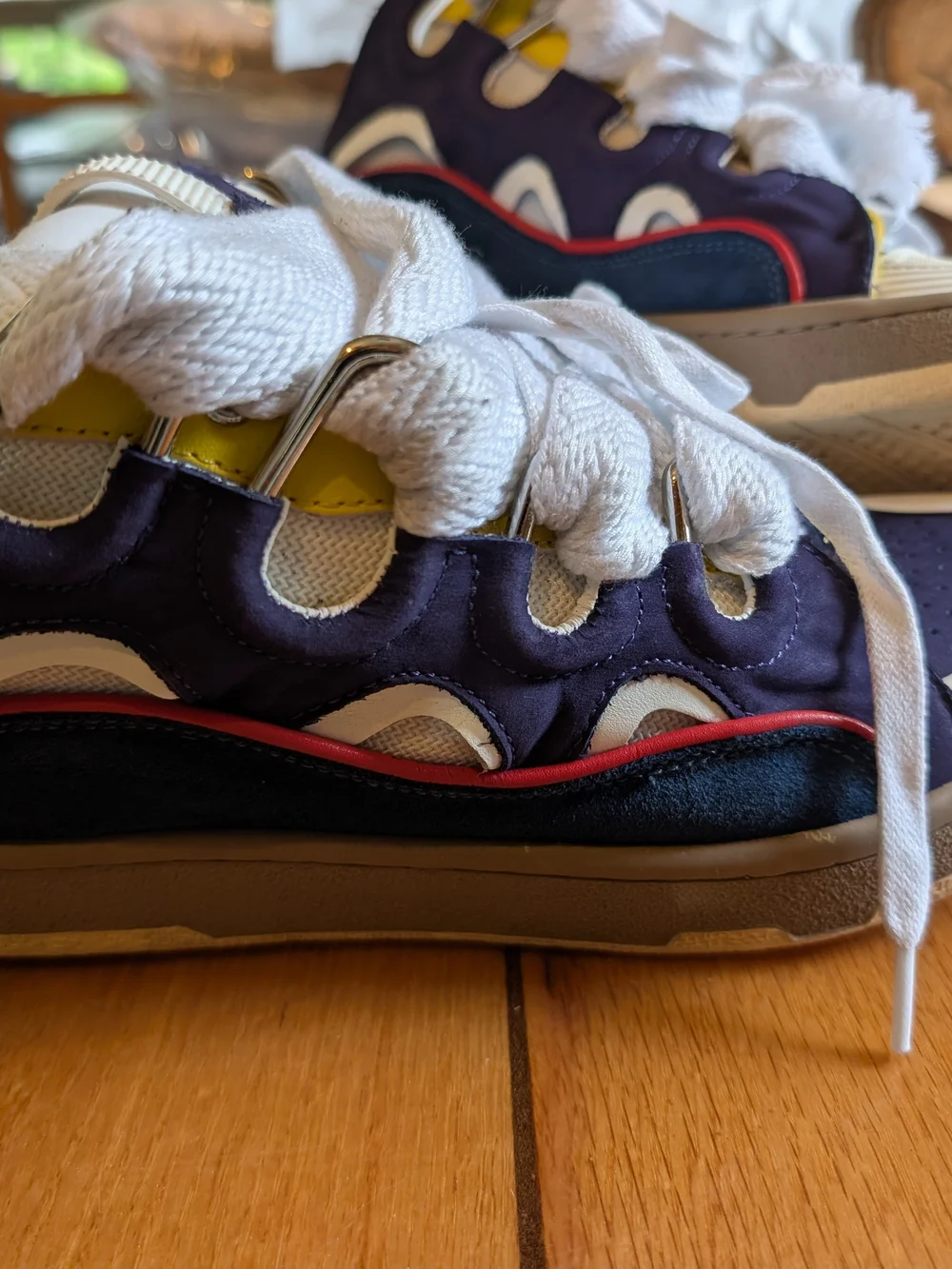 Lanvin Curb Sneakers in a distinct Navy Blue, White, Red, and Yellow colorway.